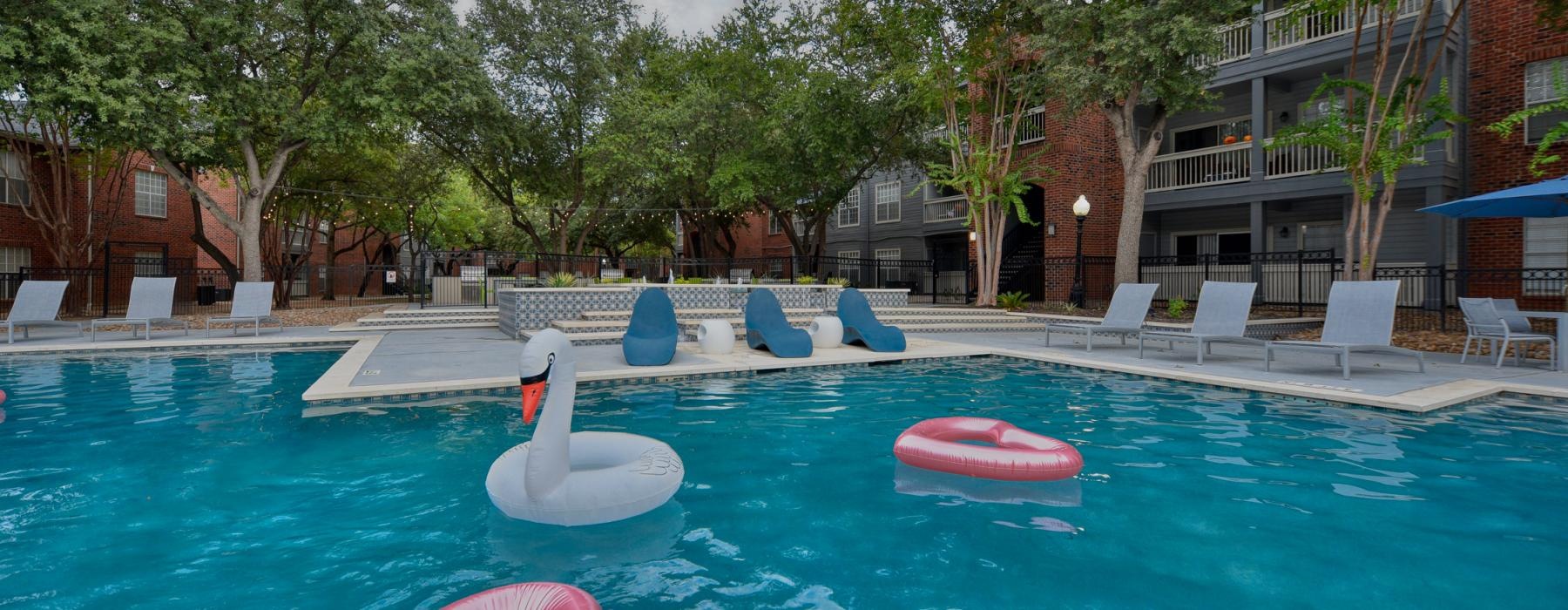 a pool with lounge seating and a toy duck in it