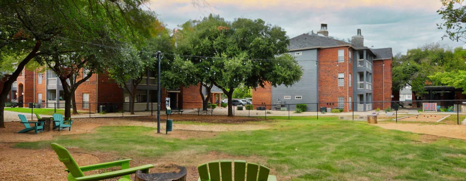 a group of green chairs in a park