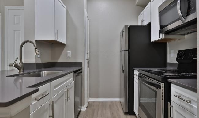 a kitchen with white cabinets