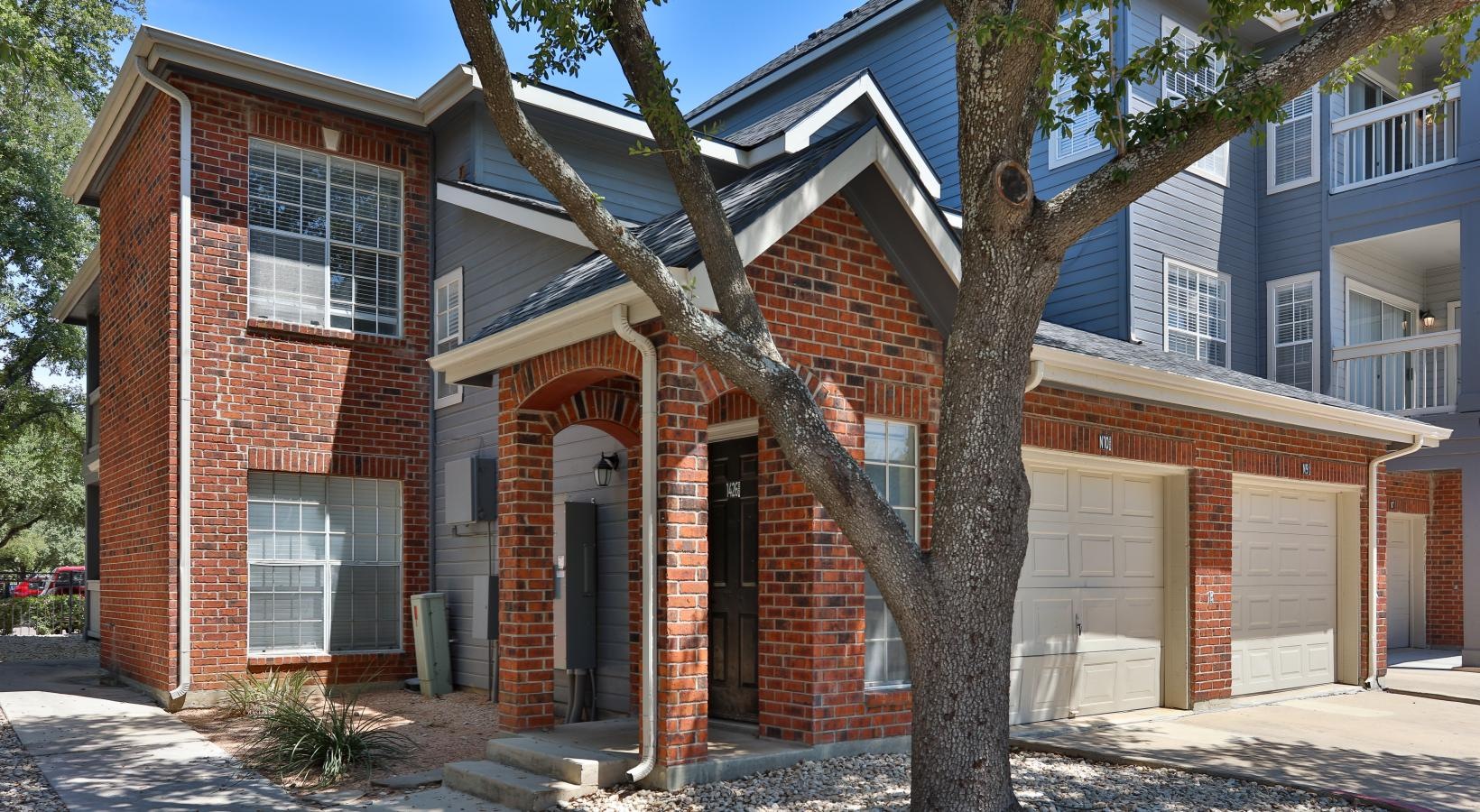 a brick building with a tree in front of it