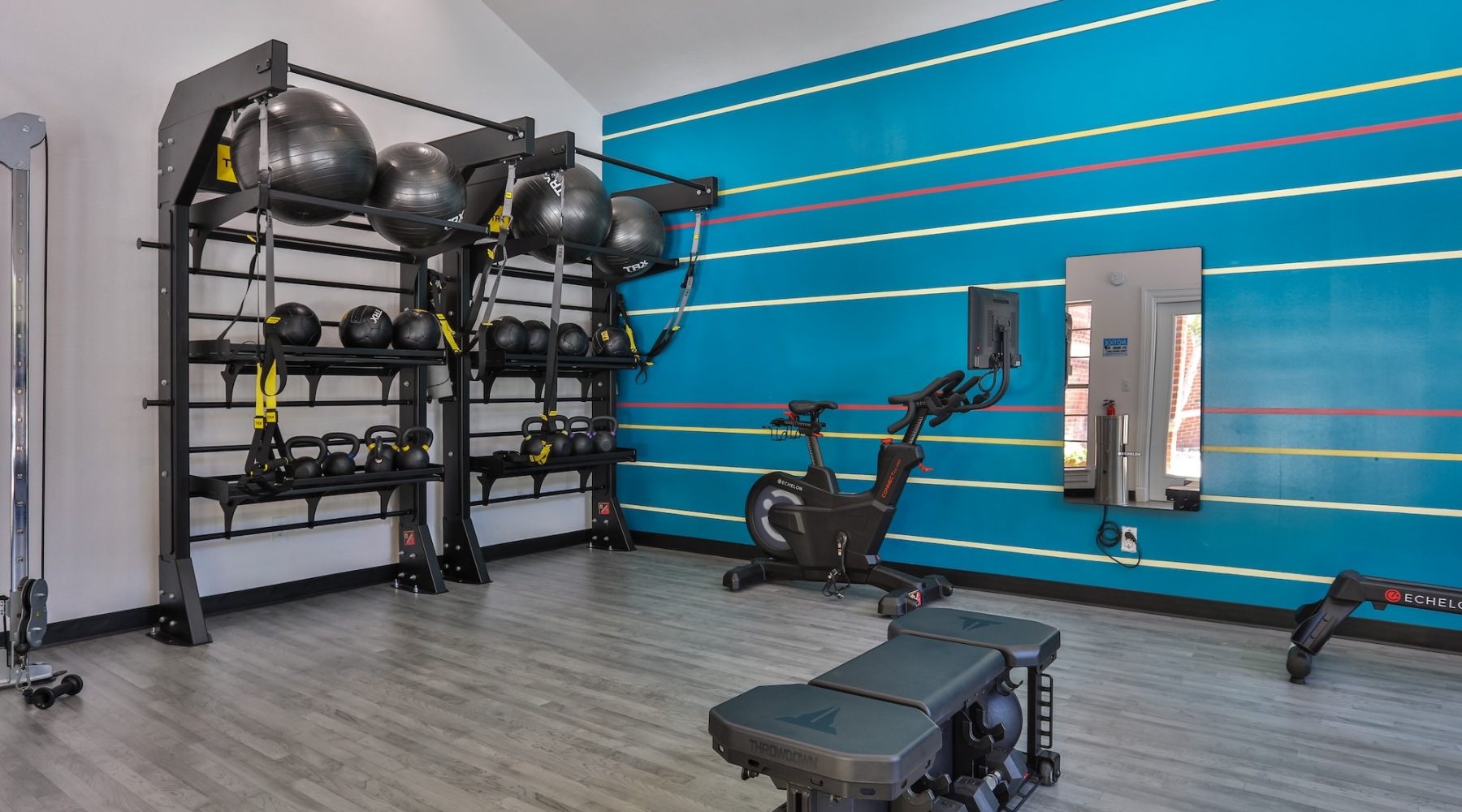 a gym with a rack of exercise equipment