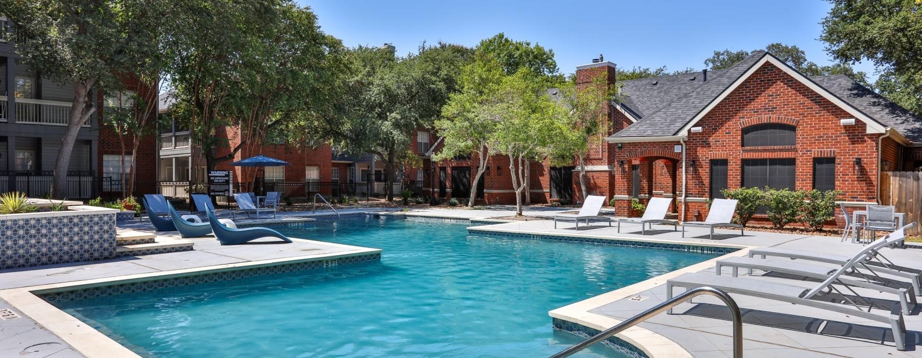 a swimming pool with chairs around it