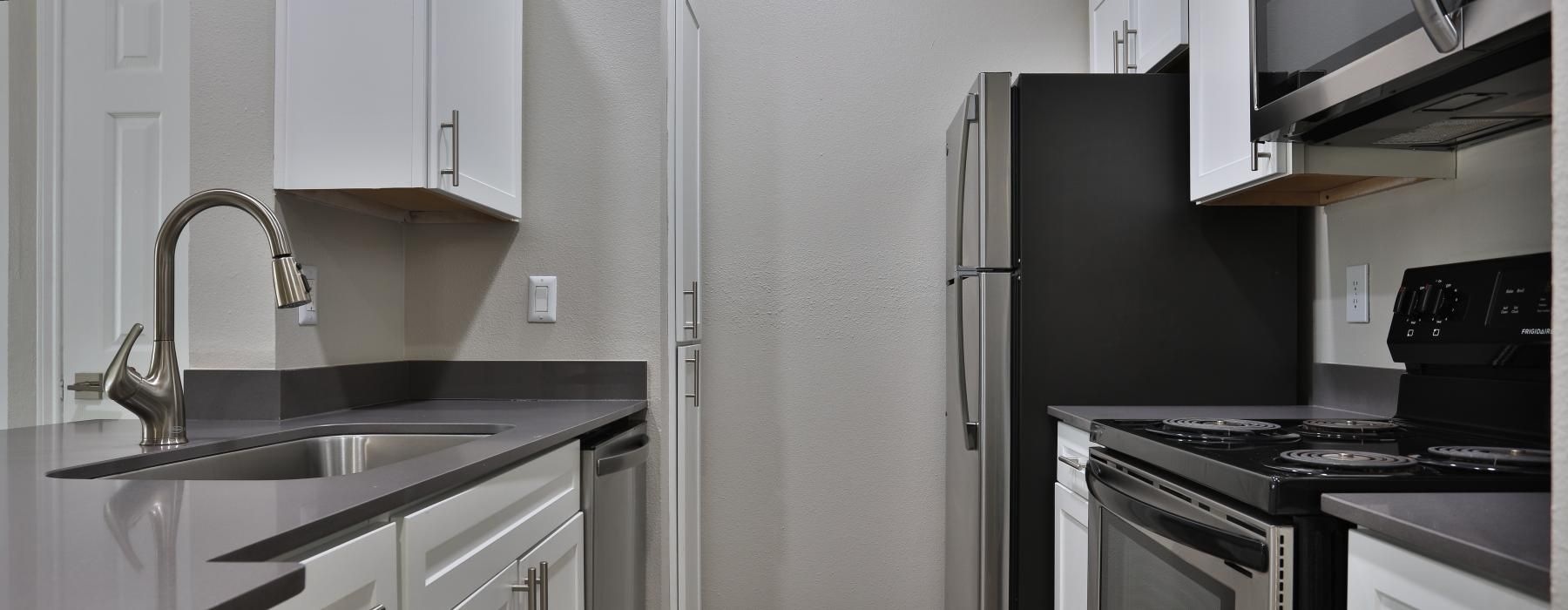 a kitchen with white cabinets