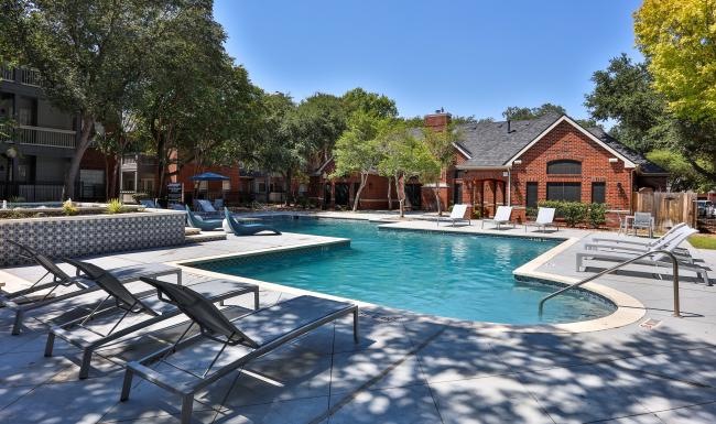 a swimming pool with chairs around it