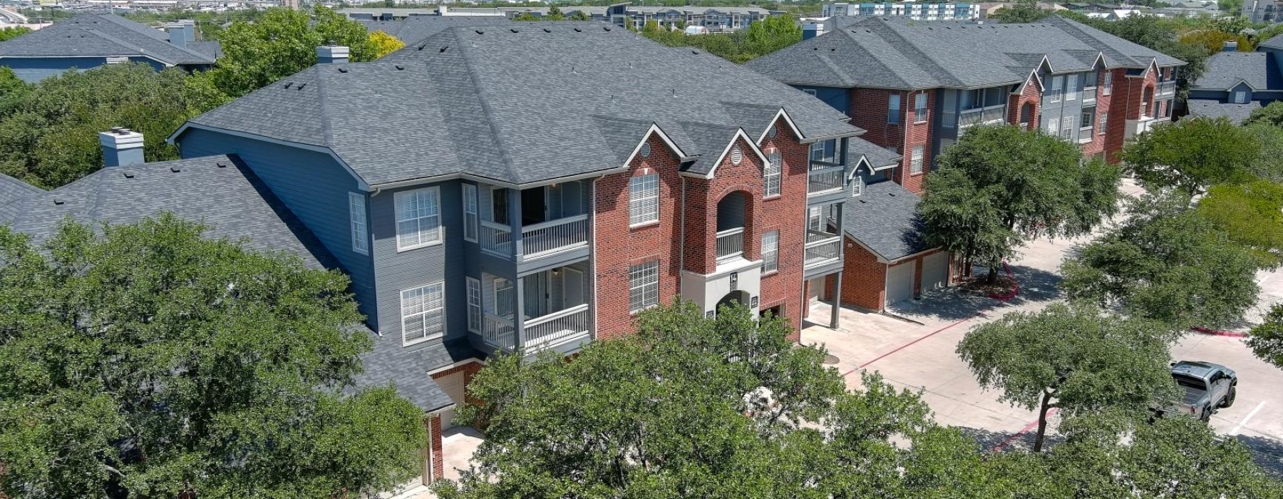 an apartment complex surrounded by trees