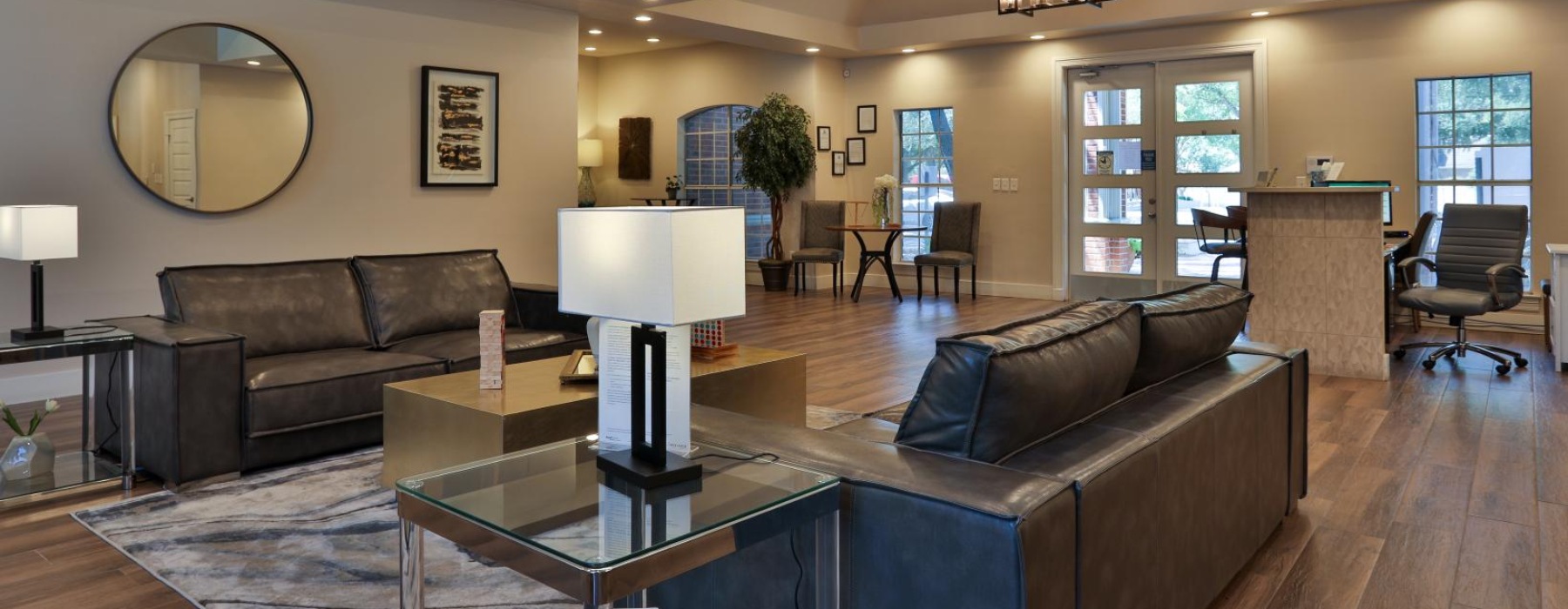 a large living room with a large glass coffee table