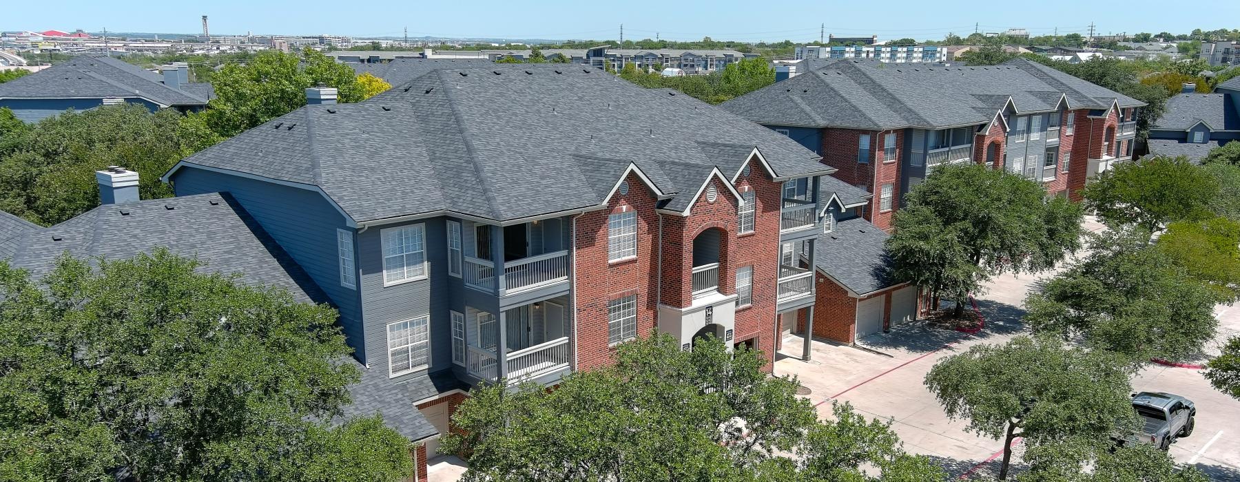 an apartment complex surrounded by trees